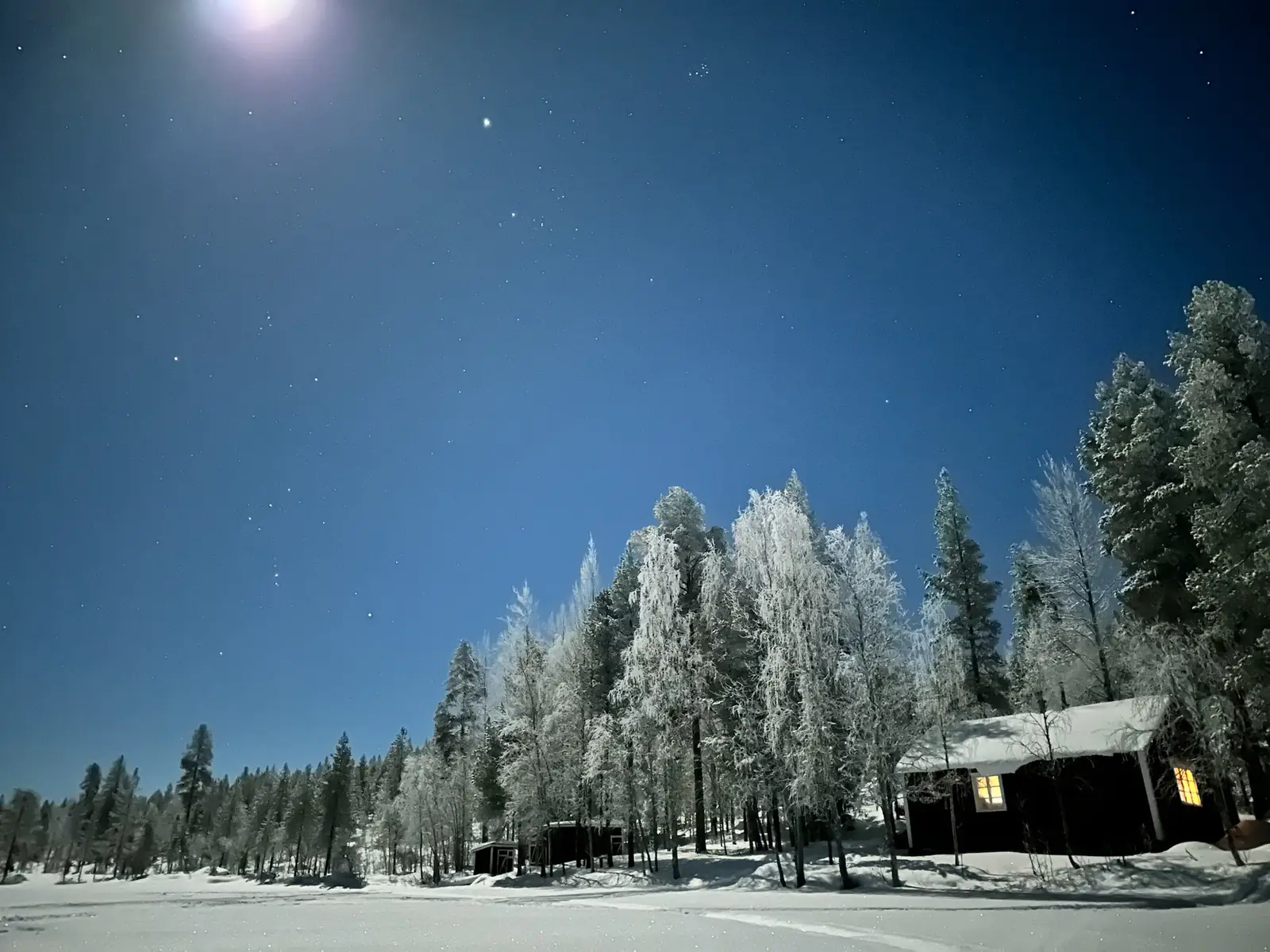 Moonlit cabin in deep winter